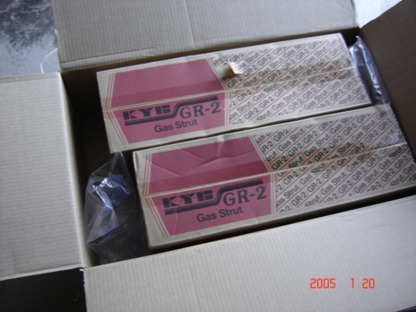 Cardboard box holding two KYB GR-2 Gas Strut boxes among other shock cartons