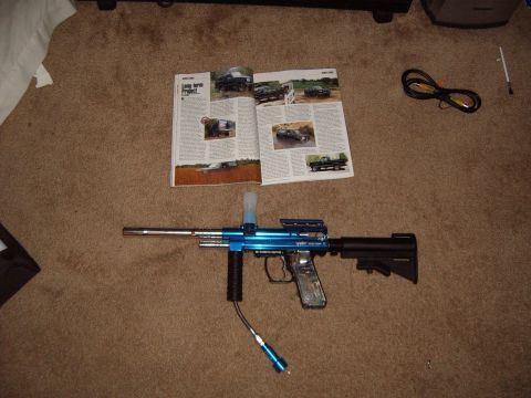 1988 Ford Bronco - A magazine trucks and SUVs is laid open on the carpet, with a blue paintball gun positioned in front of it.