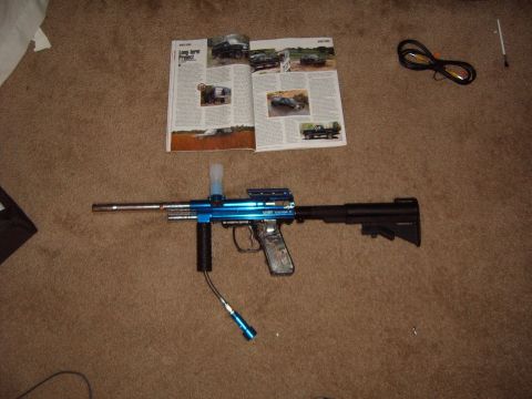 1988 Ford Bronco - A blue paintball gun and an open magazine are on a carpeted floor.