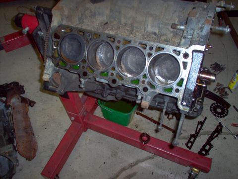 1994 Ford Crown Victoria - Engine block on a stand, likely for repair or parts. Visible text 'SUPERMOTORS.NET'.