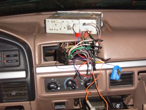 1993 Ford Bronco - The dashboard of a 1993 Ford Bronco shows exposed wiring for an aftermarket radio installation.