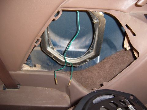 1993 Ford Bronco - Close-up view of an interior speaker mounting bracket with exposed green wires and brass connectors.