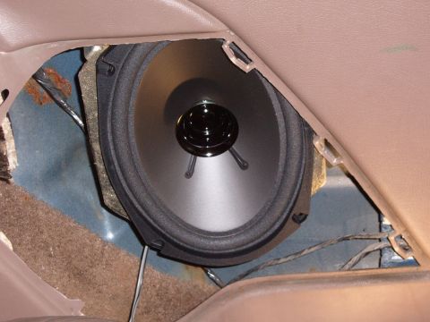 1993 Ford Bronco - Close-up of a car door speaker, revealing the interior panel and wiring.