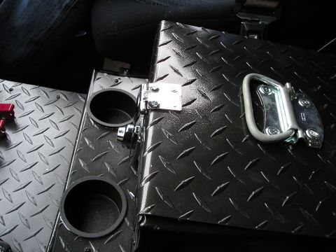 1996 Ford Bronco - Custom center console with cup holders and a latch, made of black diamond plate material.