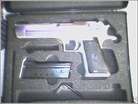 1993 Ford Bronco - A pistol and its magazine are presented in a fitted black case.