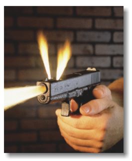 1993 Ford Bronco - Hand firing a Glock pistol, showing muzzle flash and ejected casings against a brick wall.