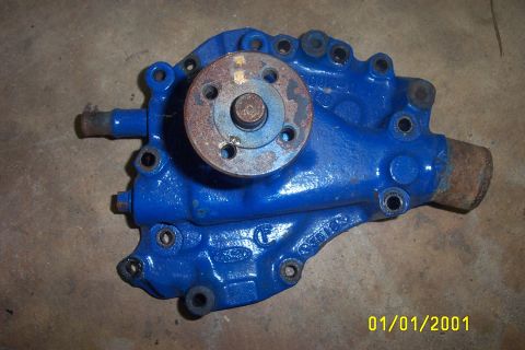 1979 Ford F-150 - This blue water pump has a Ford logo cast into its housing, indicating it's a Ford part.