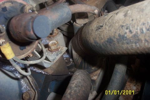 1979 Ford F-150 - A detailed view of engine components, including hoses and wiring, covered in dirt and grime.