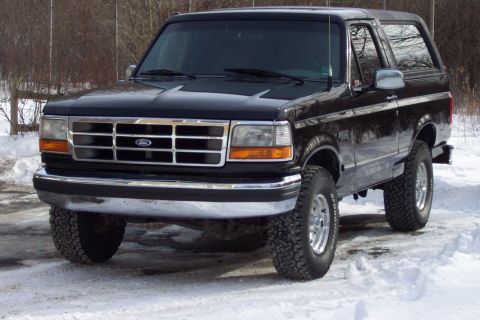 1995 Ford Bronco - This 1995 Ford Bronco is shown in a front 3/4 view, parked in a snowy environment.