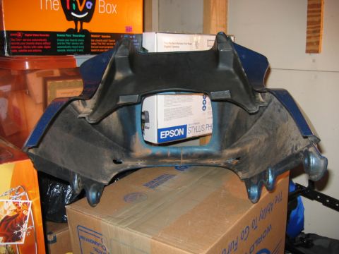 1985 Ford LTD Crown Victoria - A blue plastic fairing part is shown with an Epson Stylus box visible through its opening.