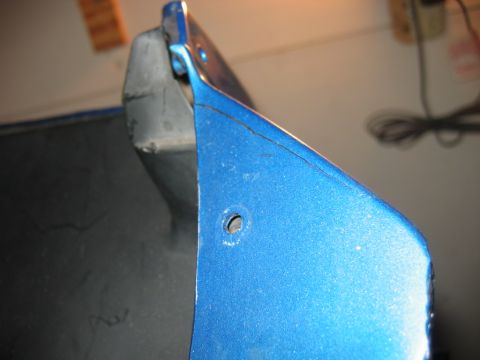 1985 Ford LTD Crown Victoria - Blue painted metal part, possibly from a vehicle, showing signs of wear and damage.