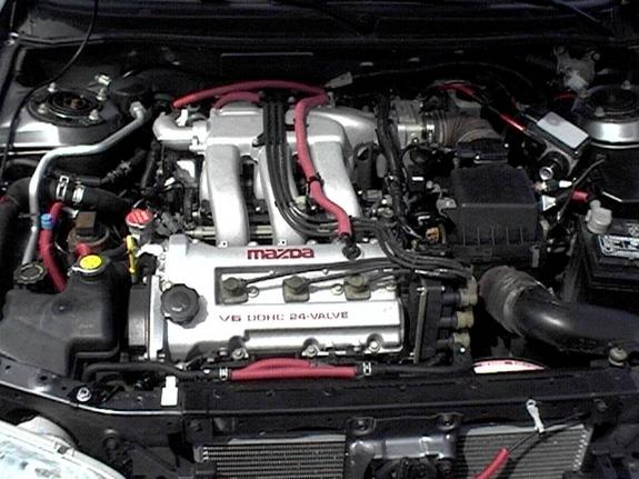 Mazda V6 DOHC 24-valve engine bay with red silicone hoses and red plug wires