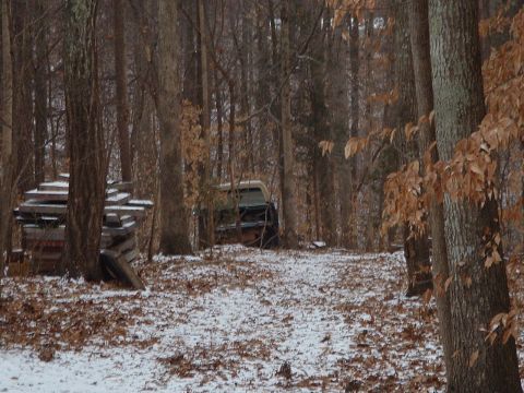 1985 Ford Bronco - If you look closely you can see the illusive "parts truck" resting peacefully in the snow behind some wall panels and trees.