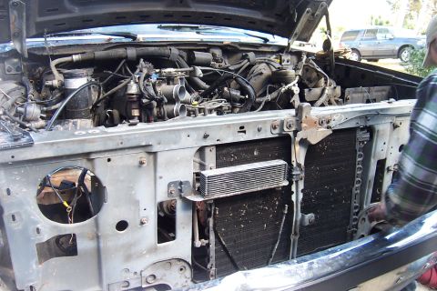 1989 Ford Bronco - Front end of a 1989 Ford Bronco with the hood up, revealing the engine and radiator assembly.