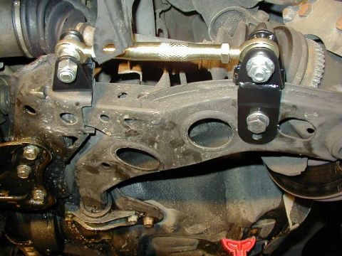 1995 Ford Probe - This photo shows an aftermarket adjustable sway bar end link installed on a vehicle's suspension system.