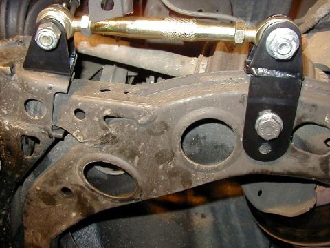 1995 Ford Probe - Close-up of an aftermarket adjustable suspension part mounted on a vehicle's undercarriage.