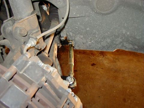 1995 Ford Probe - Close-up view of an adjustable traction bar installed on the suspension system, adjacent to the brake caliper.