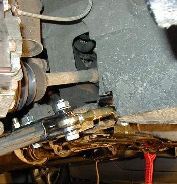 1995 Ford Probe - Underside view of a vehicle's suspension components, including a traction bar and axle.