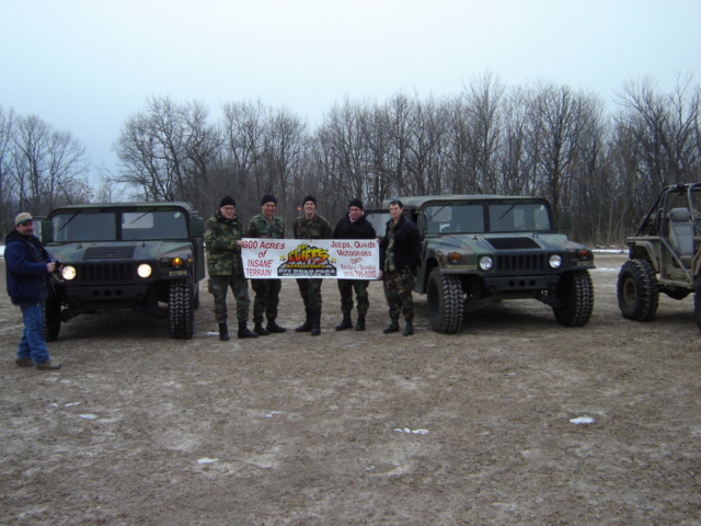 Humvee with group holding banner