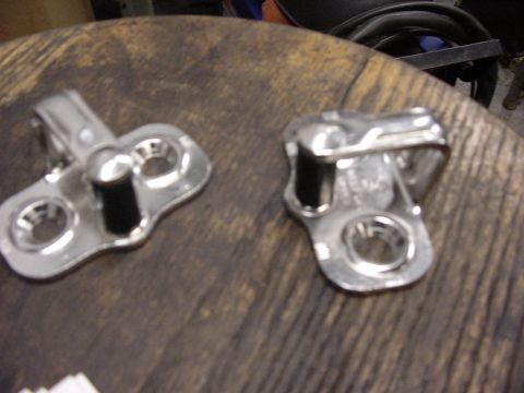 1998 Volkswagen Jetta - Two metal door latches are shown on a wooden surface, with a website watermark at the bottom right.