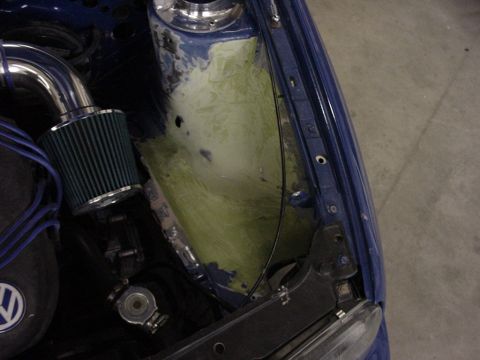 1998 Volkswagen Jetta - Close-up view of a vehicle's engine bay, showing an aftermarket air intake and areas of repair or modification.