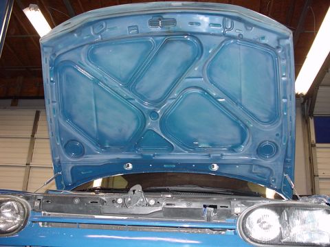 1998 Volkswagen Jetta - The underside of a car's hood is shown, revealing its internal structure and bracing.