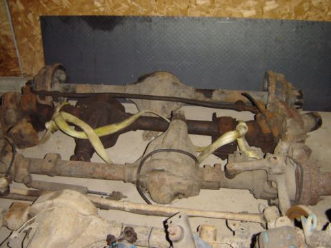 1992 Ford Bronco - Multiple vehicle axles are shown, some secured with yellow straps, in this parts listing.