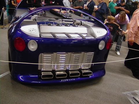 1999 Ford Taurus - This heavily modified vehicle features a unique rear design with prominent exhaust outlets and visible engine parts.