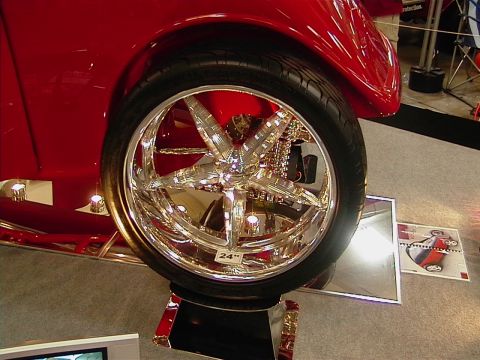 1999 Ford Taurus - A highly customized vehicle features a large, gleaming chrome wheel with a unique spoke design.