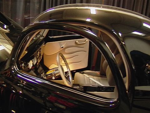 1999 Ford Taurus - Interior view of a custom car with unique flame detailing on the door panel and a white steering wheel.