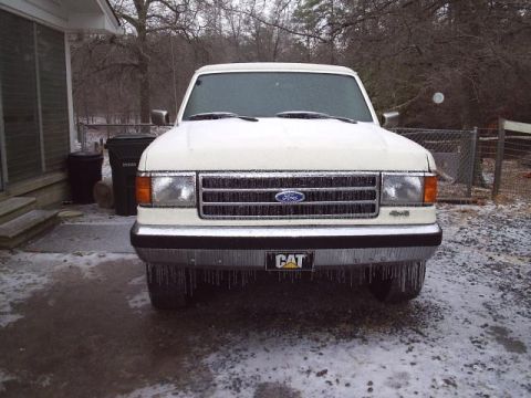 1989 Ford Bronco - White 1989 Ford Bronco parked outside in icy conditions, with icicles on the bumper.