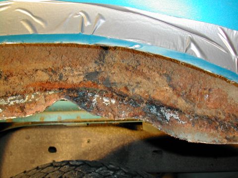 1994 Ford Bronco - Severe rust damage is visible on the fender trim and surrounding metal components.