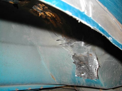 1994 Ford Bronco - This photo shows significant rust and repair work on the inner fender area of a vehicle.