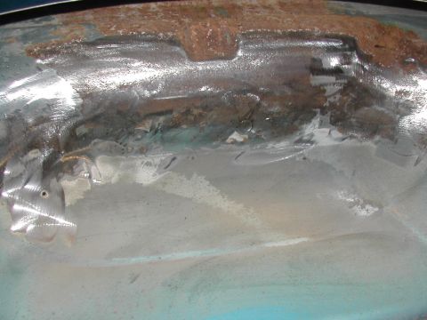 1994 Ford Bronco - This photo shows a section of a vehicle's metal body undergoing repair work, with visible rust and grinding marks.