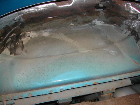 1994 Ford Bronco - Close-up of a vehicle's wheel well interior, showing signs of rust and repair work.