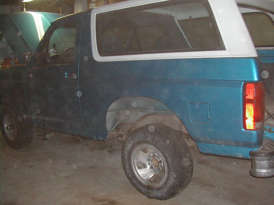 Teal SUV side view, white top, 1994 Ford Bronco
