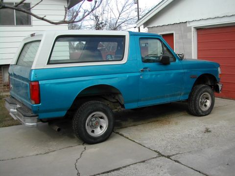 1994 Ford Bronco - This 1994 Ford Bronco is parked in front of a garage with a red door.