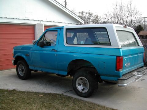 1994 Ford Bronco - This is a 1994 Ford Bronco, viewed from the rear three-quarter angle, parked in a driveway.