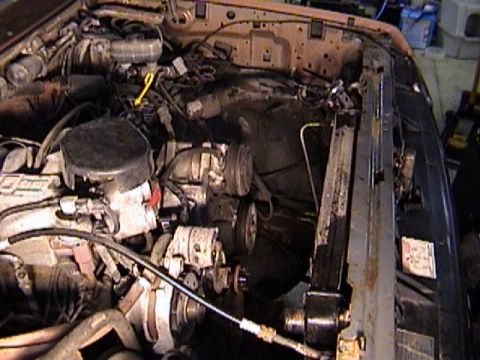 1990 Ford Bronco - After removing fan, shroud, air box, washer fluid and coolant resevoirs and bracket.