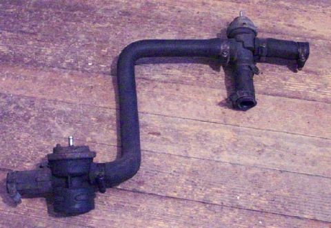 1985 Ford LTD Crown Victoria - A black metal hose and valve assembly is shown against a wooden surface.