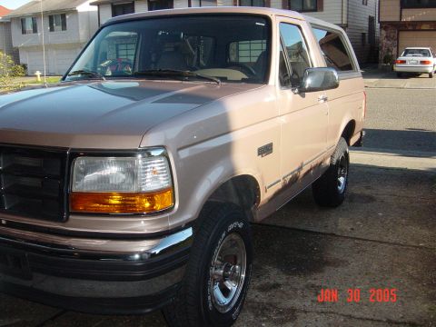 1990 Ford Bronco - This 1990 Ford Bronco is shown in a 3/4 front view, parked in a driveway.