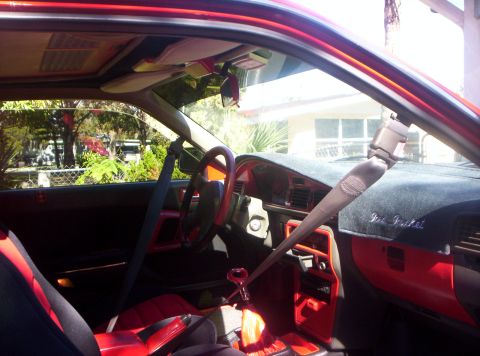 1991 Mazda MX-6 - Interior view of a 1991 Mazda MX-6 with red accents on the dashboard and seats.