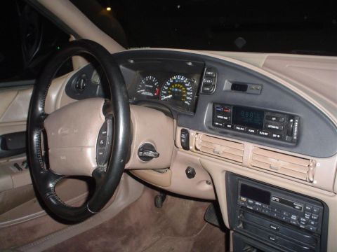 1993 Ford Taurus - The interior of a 1993 Ford Taurus is captured, highlighting the driver's side dashboard and controls.