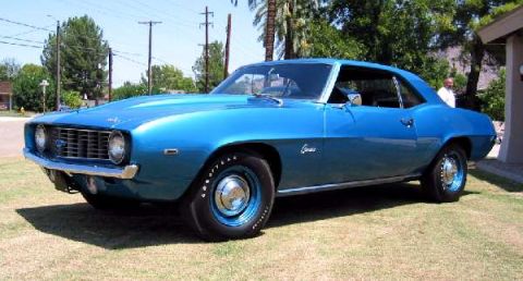 1990 Ford Taurus - Blue 1969 Chevrolet Camaro coupe with chrome trim and rally wheels.
