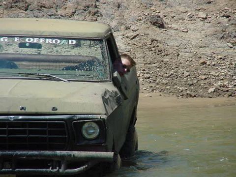 1978 Ford Bronco - This 1978 Ford Bronco is navigating through a body of water, with a driver visible.