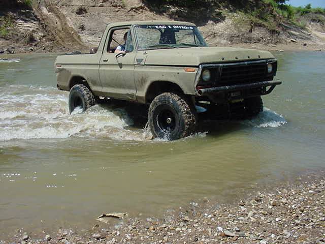 Ford F-Series truck driving through water. Text on windshield reads "EAGLE OFFROAD"