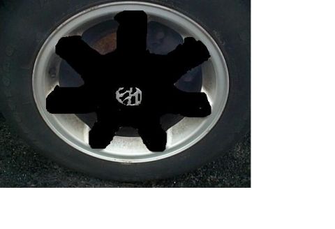 2003 Chevrolet Monte Carlo - A close-up of a wheel shows a blacked-out center cap with a visible Volkswagen logo.