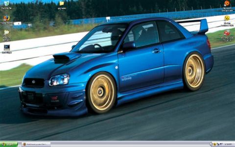 1990 Ford Bronco - This Subaru Impreza WRX STI is shown on a race track with gold aftermarket wheels.