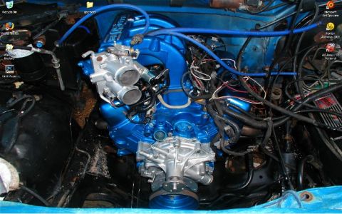 1990 Ford Bronco - The engine bay features a custom painted blue engine with prominent intake and fuel lines.