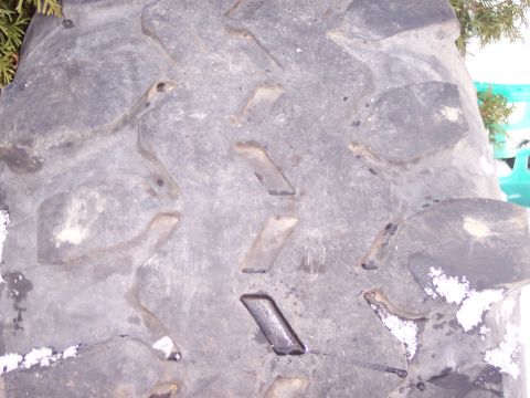 1974 Ford Bronco - This is a close-up view of a tire's tread pattern, showing its aggressive design for off-road use.